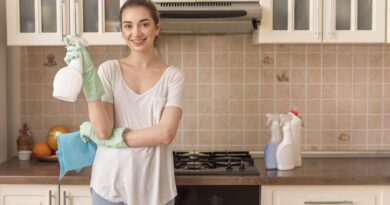 smiley woman kitchen holding ablution cloth